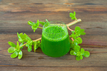 Green herb smoothie on  wooden brown table