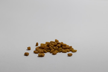 Close-up of Fenugreek seeds on a white background, used to make a dip for Yemeni immigrants