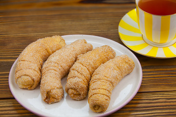 Tasty crispy fresh cookies on a plate on a wooden background