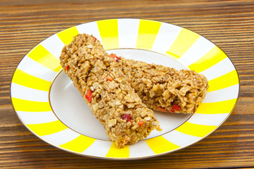 Crispy appetizing bread with strawberries on a plate on  wooden background