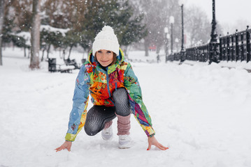 A beautiful young girl is Jogging on a frosty and snowy day. Sports, healthy lifestyle