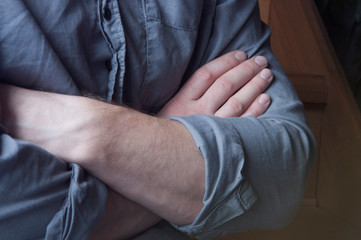Clasped hands. Hands of a man in a shirt.
