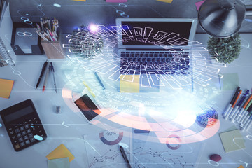 Double exposure of data drawing hologram over topview of study desk background with computer. Concept of Ai.