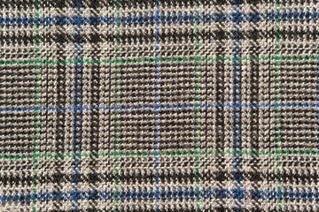 Plaid wool fabric background. Amazing texture of warm textile for winter coats.