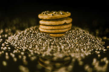 Medical Cannabis Seeds and CBD Cannabis Cookies on the black mirroring background.