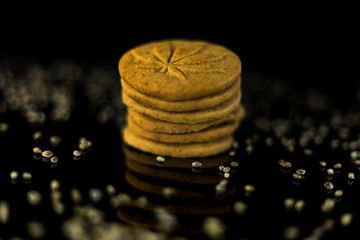 Medical Cannabis Seeds and CBD Cannabis Cookies on the black mirroring background.