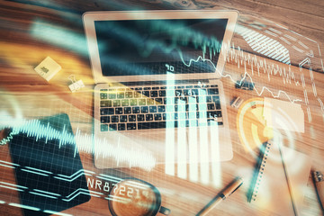 Technology hologram drawing over computer on the desktop background. Top view. Double exposure. Tech concept.