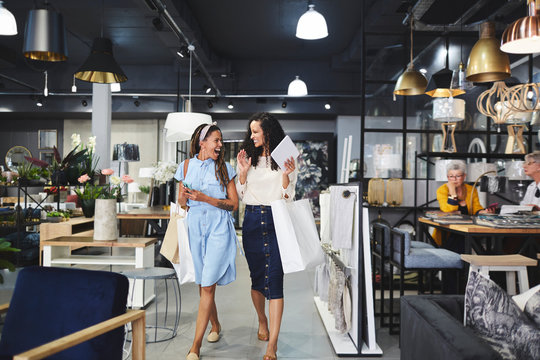 Women shopping leaving home decor shop