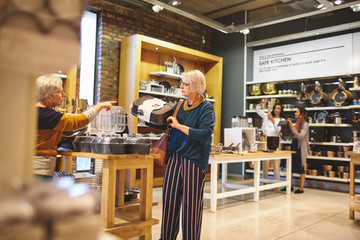 Senior women shopping for bakeware in home goods store