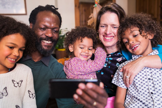 Happy Multiethnic Family Taking Selfie With Camera Phone