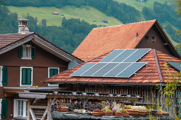 Solar panel on a red roof of a building. Green energy