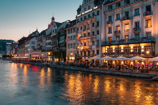 Historic city center of Lucerne, promenade and river Reuss. Nice summer evening. Popular touristic place with restaurants and cafes.