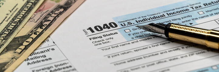 1040 individual tax return form and dollar bils