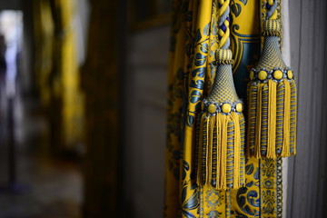 detail of a yellow tassel at the Palace of Versailles