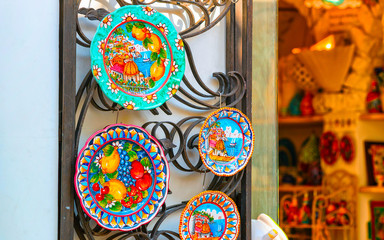 Traditional colorful ceramics plates in Positano town reflex