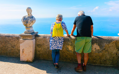 Senior people looking at sea in terrace in Ravello village reflex