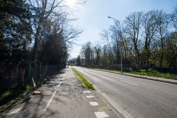 Fototapeta premium Silhouete of lonely cyclist on empty street in France due to coronavirus outbreak