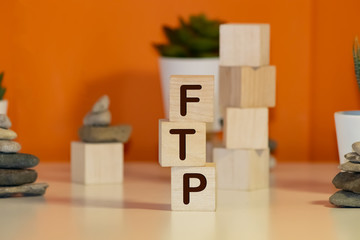 The Word FTP Formed By Wooden Blocks On A White Table