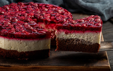 Cut cherry cake with chocolate white and dairy