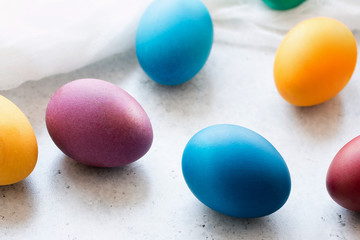 Colorful easter eggs on grey concrete table. Front view. Selektive focus. Easter decoration. 