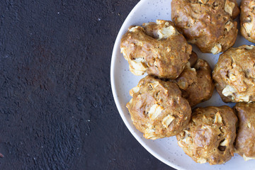 Soft and tender apple biscuits on a ceramic plate, dark concrete background. Dessert or breakfast for children, sweet snack. Selective focus.