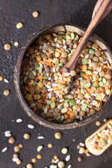 White rice and different types of lentil, dark brown concrete background. Agricultural product concept.