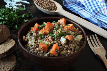 Buckwheat porridge with vegetables in a bowl. View from above. Dietary food. Quarantine food.