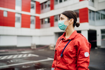 Paramedic in front of isolation hospital facility.Coronavirus Covid-19 heroes.Mental strength of medical professional.Emergency room doctor prepared for virus outbreak.Ready for hard work.Brave nurse