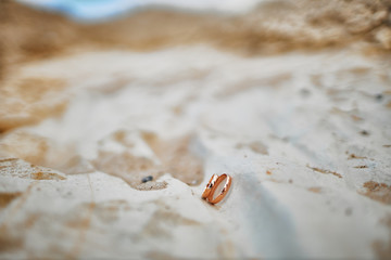 gold wedding rings on stones