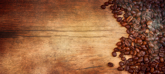 Coffee cup and beans on old kitchen table.