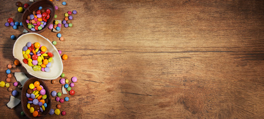 Fototapeta na wymiar Colorful Easter candies on a rustic wood background