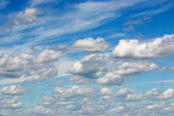 Blue sky with white cumulus clouds.