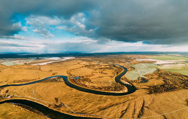 Aerial View Of Dry Grass And Partly Frozen River Landscape In Late Autumn Day. High Attitude View. Marsh Bog. Drone View. Bird's Eye View
