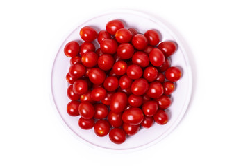 Cherry tomatoes in a bowl isolated on a white background.