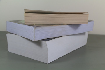 Heap of three books on a table