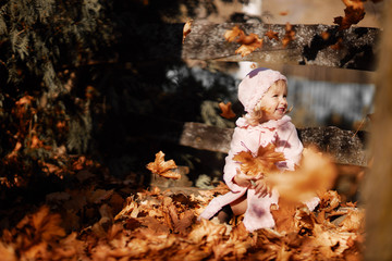 Fashionable little girl in a pink coat