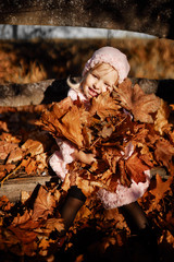 Fashionable little girl in a pink coat