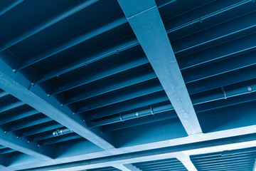 Obraz premium Abstrakte Stahlkonstruktion, Blaue Brücke von unten, Blauer Stahl, Industrielandschaft, Hintergrund Blau