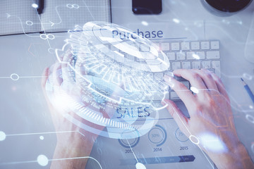 Multi exposure of man's hands typing over computer keyboard and data theme hologram drawing. Top view. Technology concept.