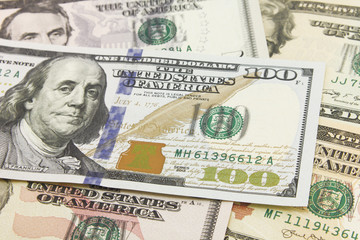 Obraz na płótnie Canvas One hundred dollar bills in cash on various banknotes background