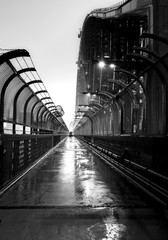 Black and white photo of Sydney Harbour Bridge in the rain