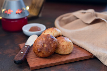 Homemade bread on wooden board with jam background