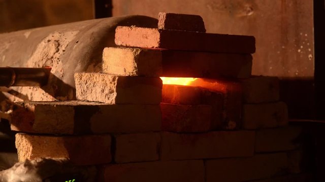 Blacksmith forging metal in a workshop