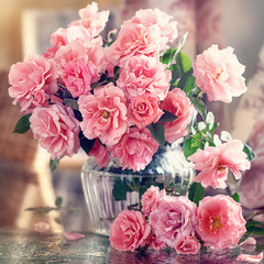 Beautiful fresh roses on a table.Close-up floral composition with a pink flowers .