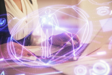 Double exposure of woman hands typing on computer and general theme hologram drawing. Education concept.