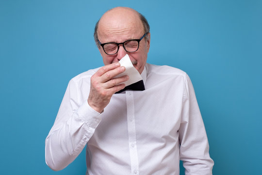 Senior Bald Caucasian Man About To Sneeze Being Ill Having Grippe