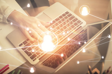 Double exposure of woman hands typing on computer and social network theme hologram drawing. People...