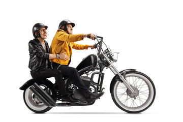 Obraz na płótnie Canvas Two senior men riding on a chopper motorbike
