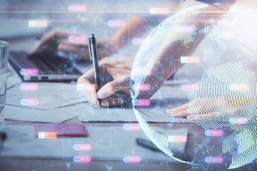 Double exposure of woman hands working on computer and world map hologram drawing. International technology business concept.