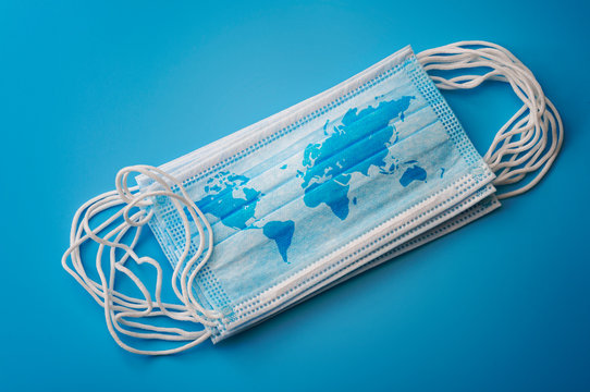 Novel coronavirus global epidemic, infectious respiratory illness spread and covid-19 pandemic concept the world map on surgical mask isolated on blue background